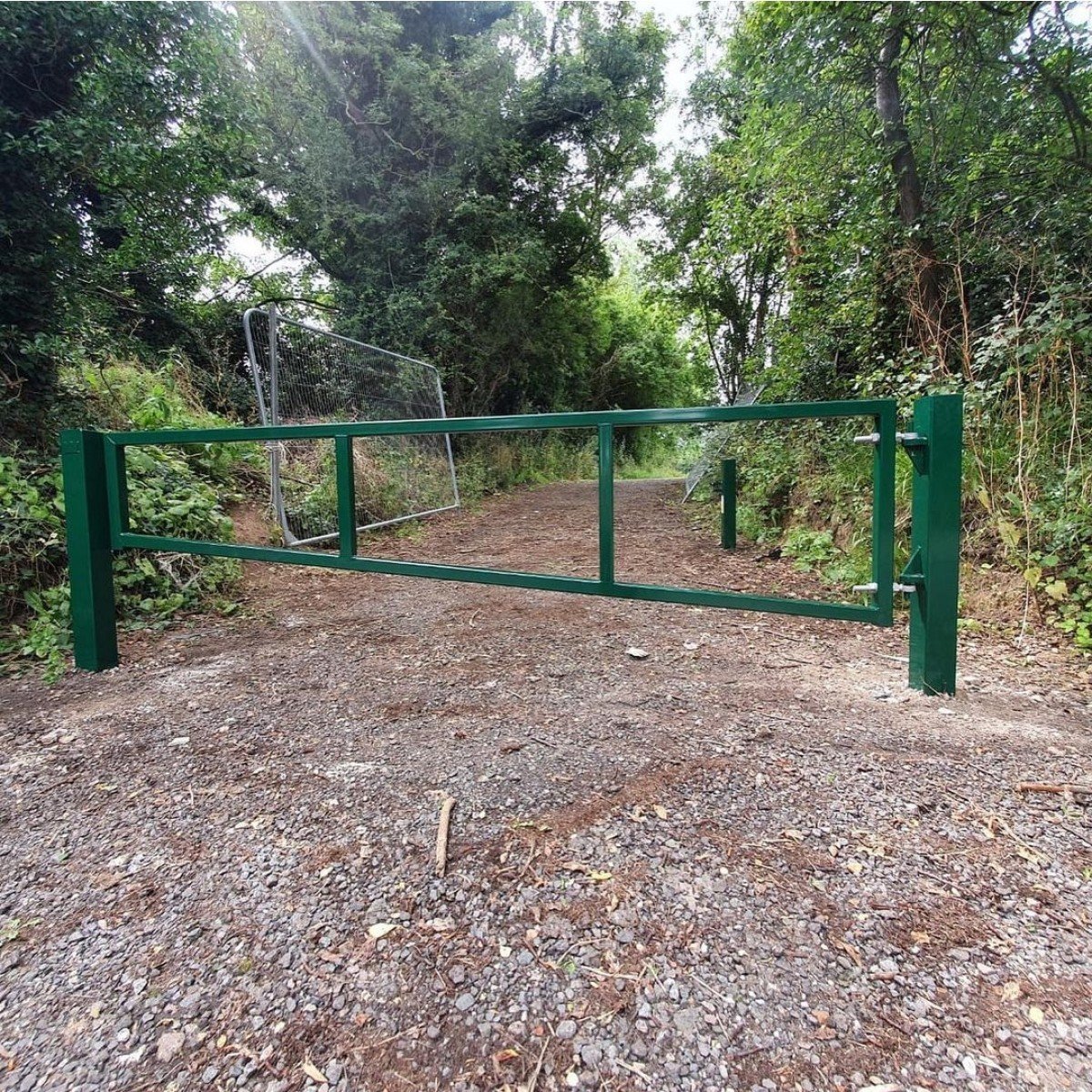 Bolt-down swing car park barrier for hard ground installation